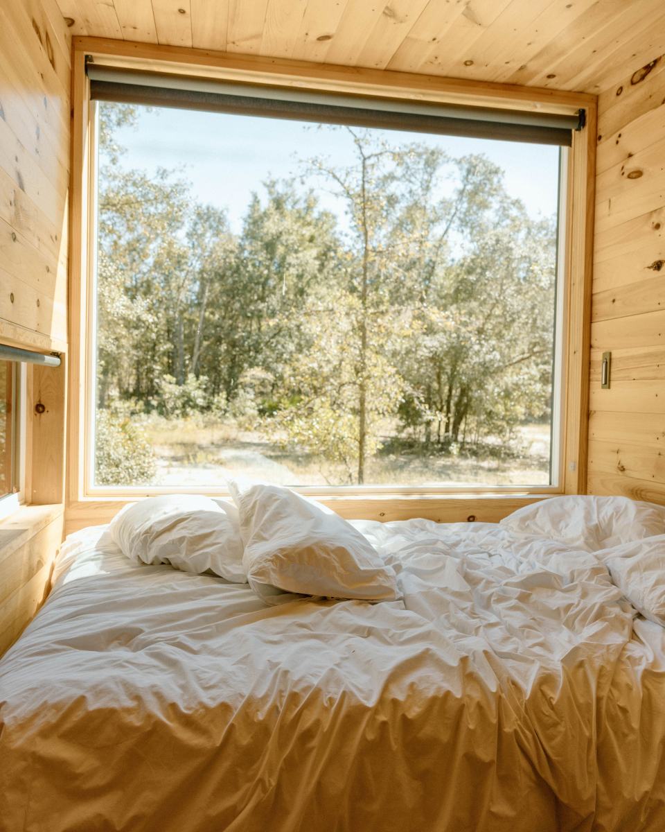A timber bedroom facing the trees