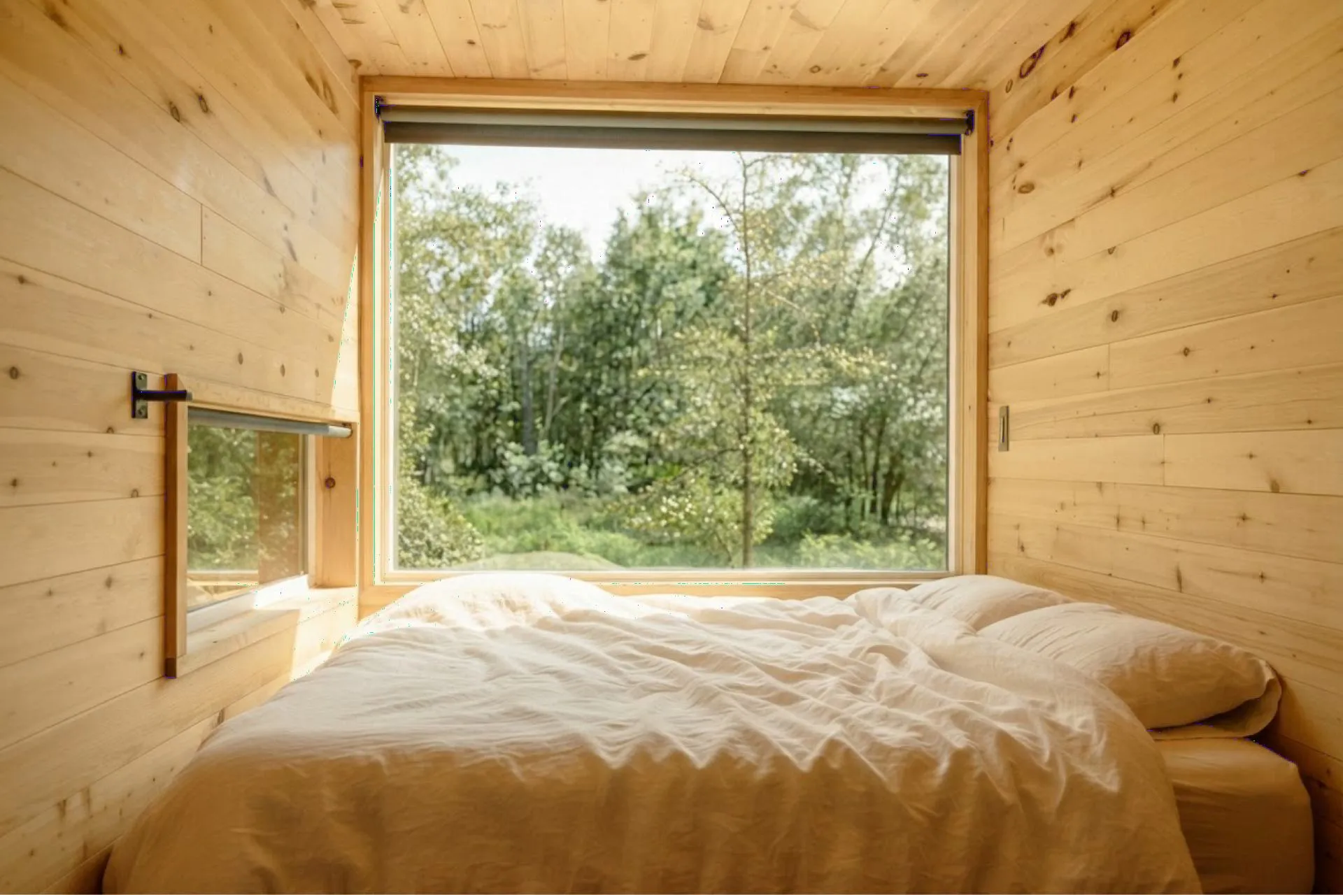 A timber bedroom facing the trees